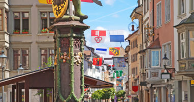 Historical center of Schaffhausen decorated with swiss cantons flags for the Swiss National day (1st August)